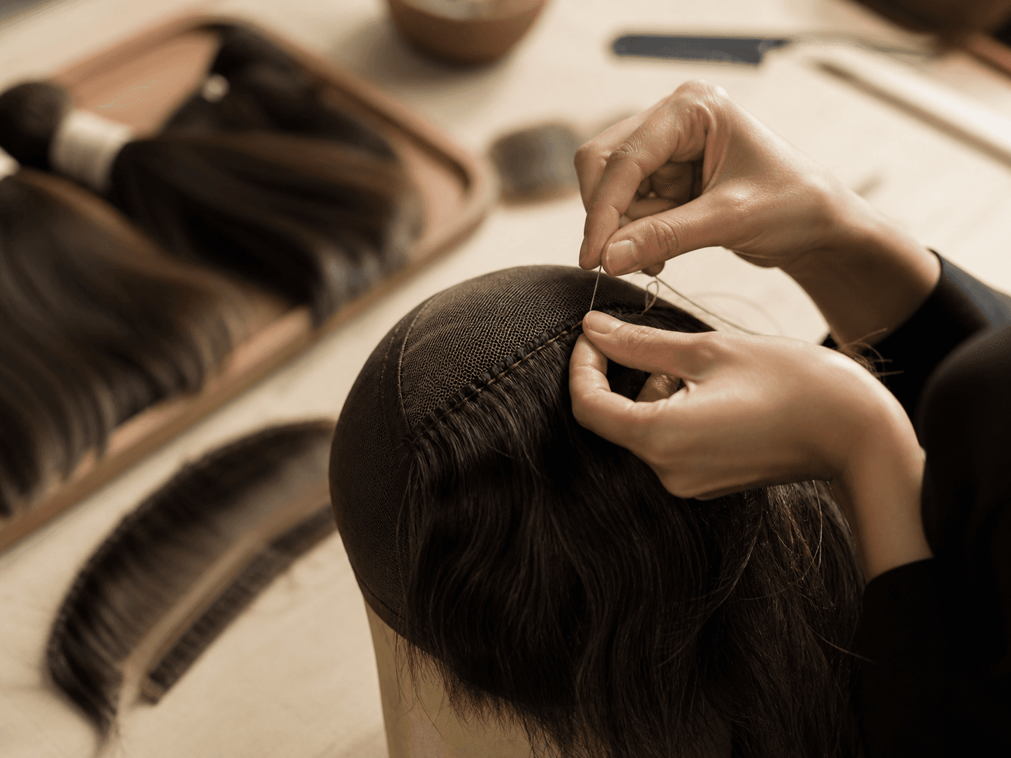 Human hair craftsmanship in a professional atelier