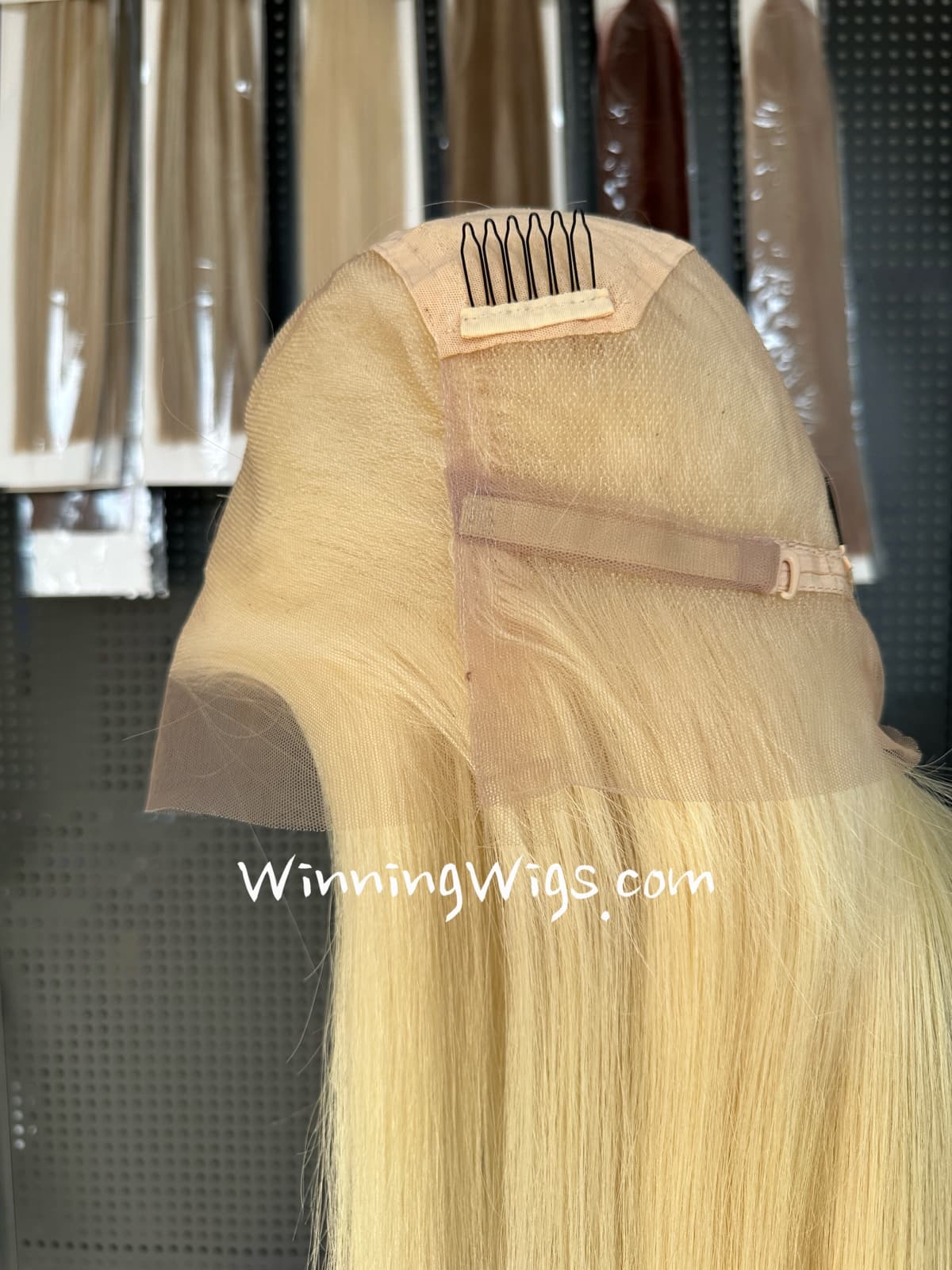 Interior of a blonde full lace virgin human hair wig with an adjustable strap and comb