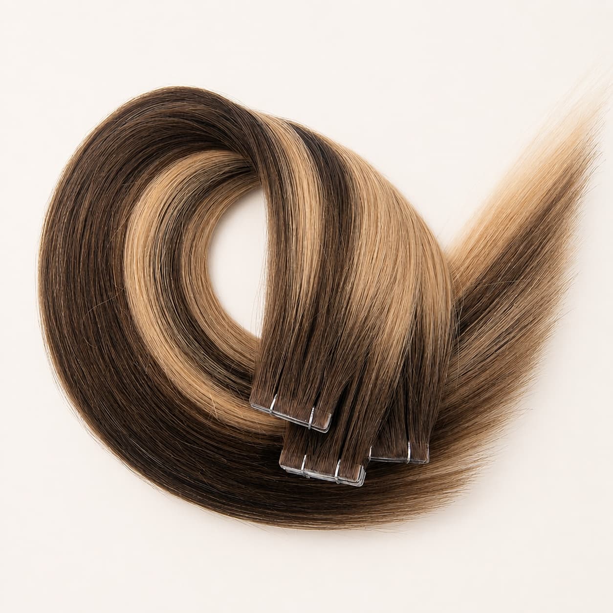 Invisible tape-in human hair extensions with a seamless low-profile attachment