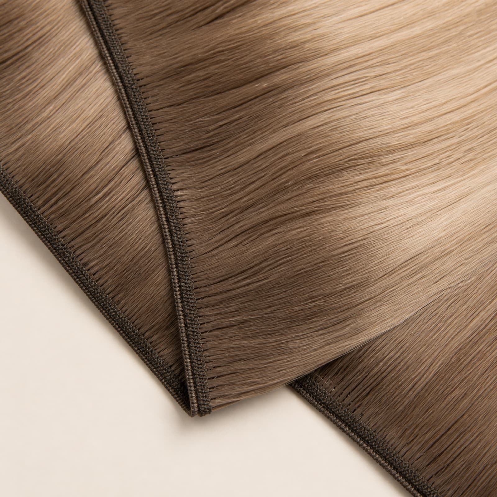 Machine Weft virgin human hair extension with reinforced sewn seam in ash brown and blonde