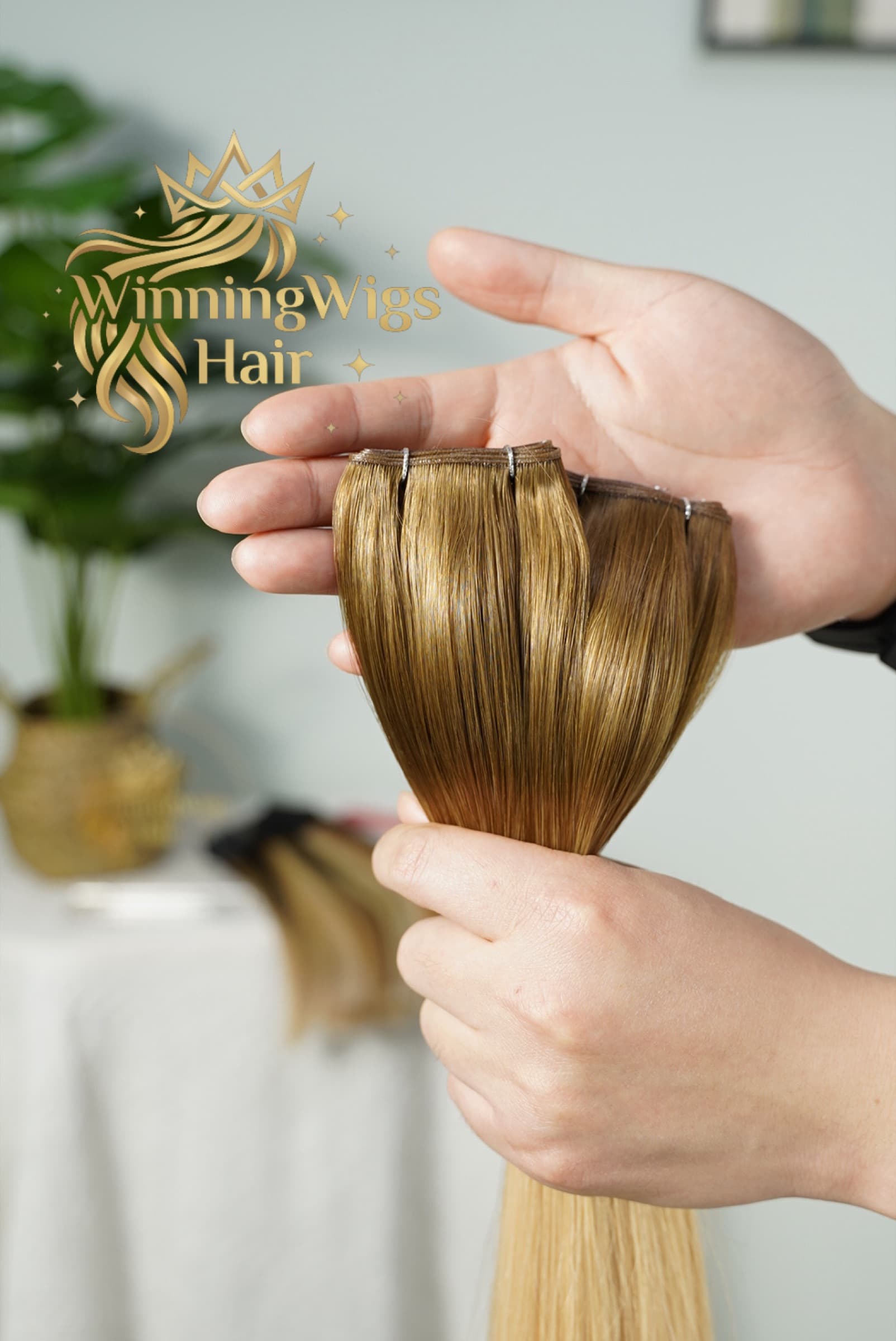Genius Weft human hair extension in a brown-to-blonde balayage shade, showing the slim flexible seam
